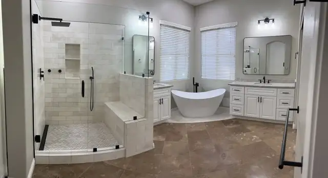 Primary bathroom remodel in Arizona with a freestanding tub, glass shower with bench seat and white double vanities